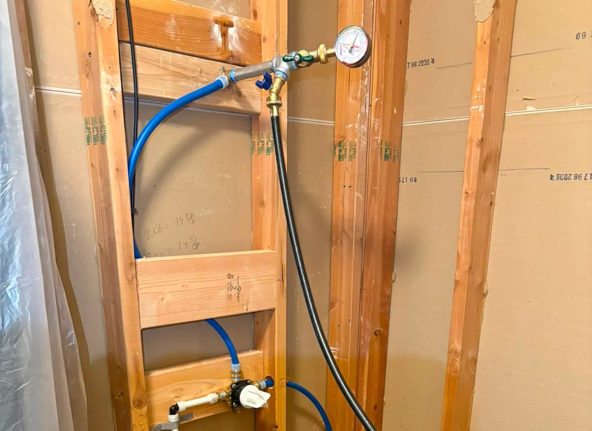 Plumber pressure testing a finished repipe