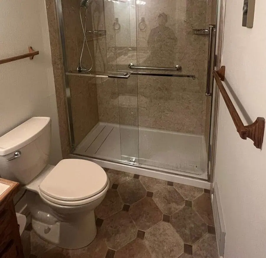 Finished bathroom with a glass shower enclosure and new toilet