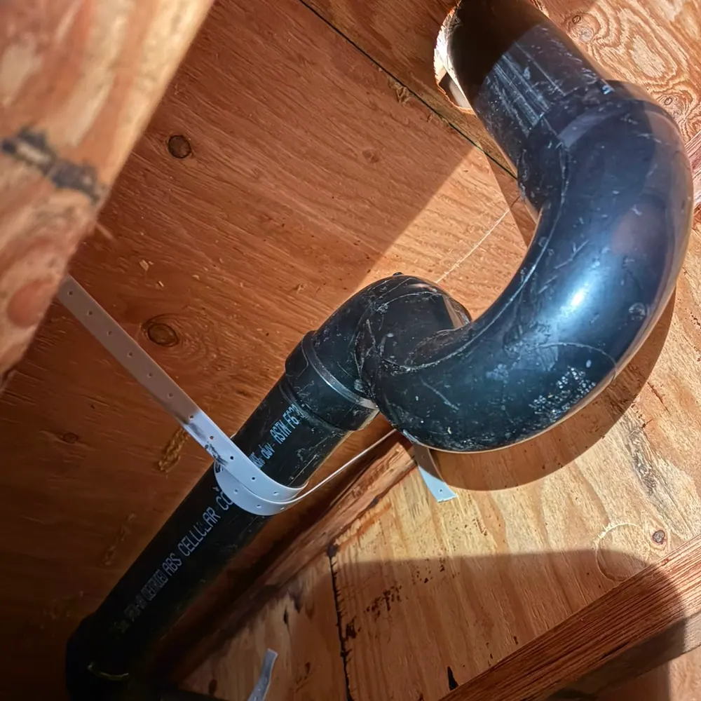 New ABS P-trap and drain assembly framed into a floor joist bay