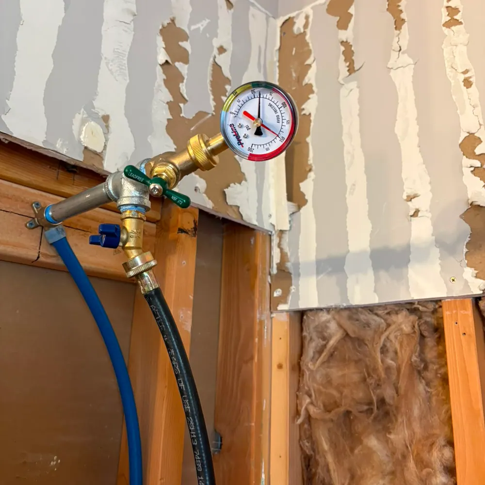 Pressure gauge on a hose bib during a whole-house pressure test
